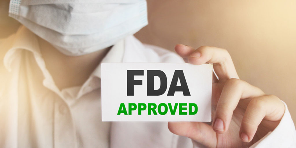 [Image description: A doctor in a white coat and mask holds up a card reading "FDA Approved."]