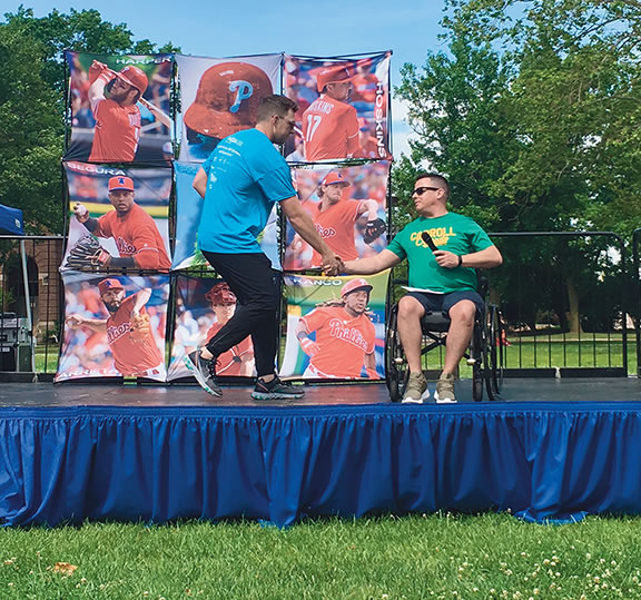Christopher (right) met Philadelphia Phillies player Rhys Hoskins and gave a speech at an MDA Muscle Walk event.