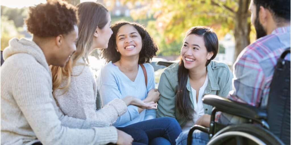 group-of-college-friends-talk-in-circle-outdoors-picture-id1074625096-2