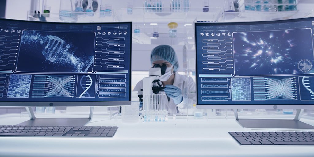 Female studying DNA samples. Computer screens with DNA sequences