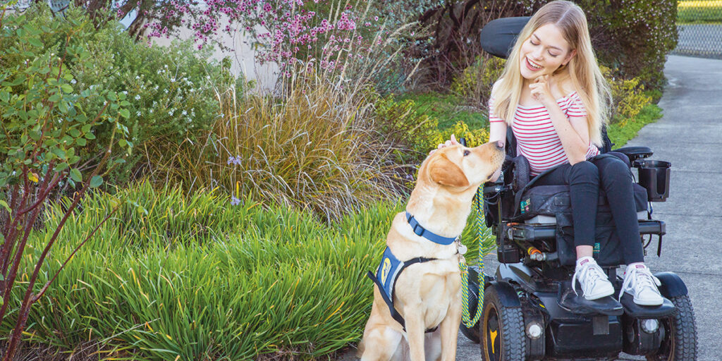 Annie, a client of Canine Companions, praises her service dog, Yardley.
