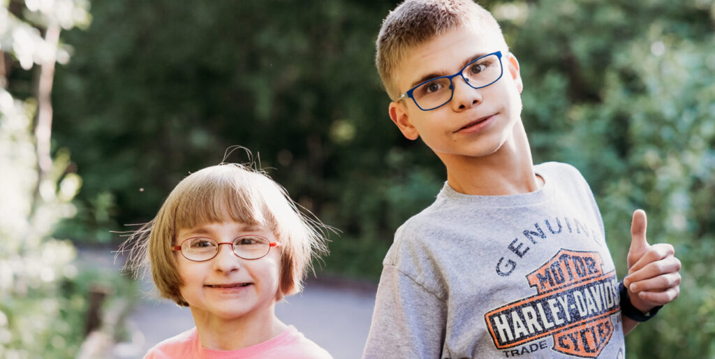 Siblings Joshua and Holly Szymczak, holding hands and wearing their Harley-Davidson t-shirts