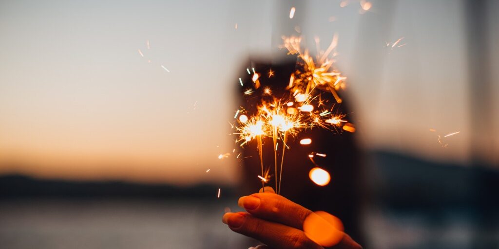 young-woman-holding-sparkler-at-the-marina-picture-id1256454563