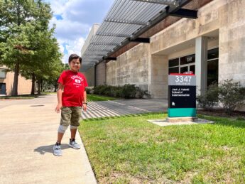 Maanav stands on sidewalk outside of school building on University of Houston campus