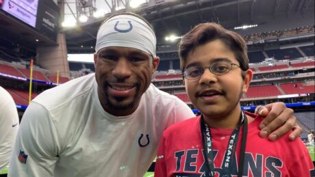 Indianapolis Colts running back and punt returner Nyheim Hines and Maanav smile with stadium lights behind them