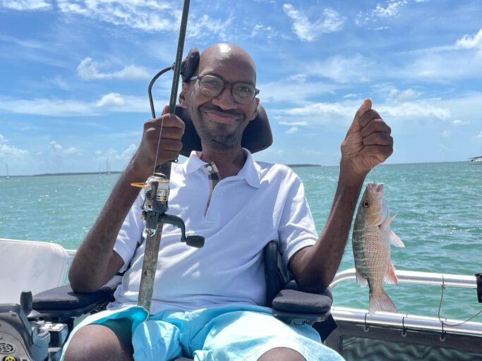 Ira Walker poses on a boat during a fishing trip