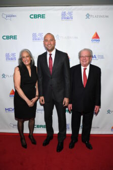 Joann Wright, Derek Jeter, and Victor Wright pose in front of an MDA backdrop