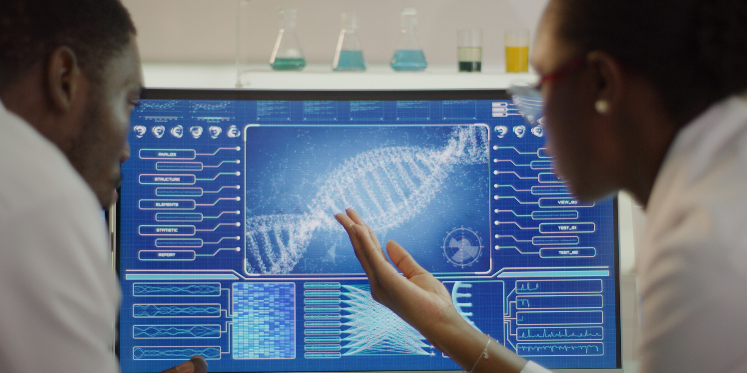 Scientist examines DNA models on a lab screen