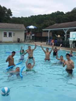 Counselors and campers in a swimming pool