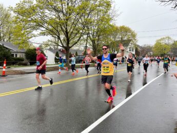 Runners at the Boston Marathon, with one runner wearing an MDA jersey