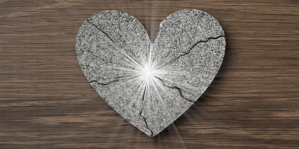 Shiny silver broken heart that shines in the middle