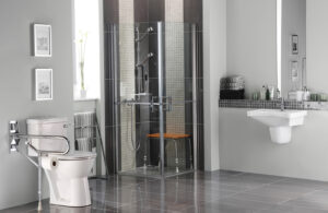 A large bathroom with zero entry shower, space below and around the sink, and grab bars by the toilet.