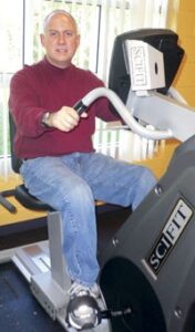 Bald White man on exercise machine