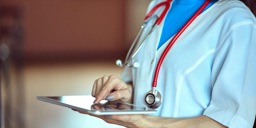 Woman doctor using tablet computer in hospital