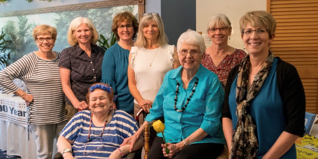 Seven sisters in their 60s with their mother