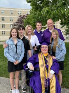 The Jurack family standing around Joshua after his graduation 