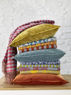 Stack of brightly colored pillows and folded blankets
