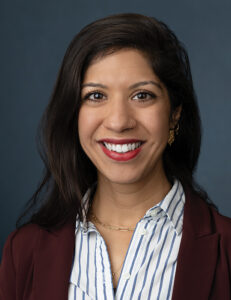 A headshot of Ambereen Mehta, MD, MPH, a brown-haired woman with brown eyes