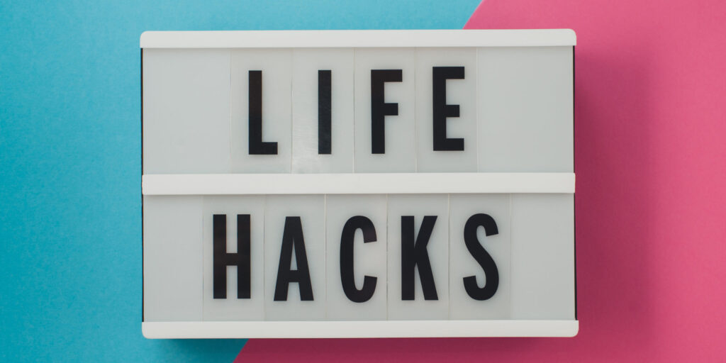 life hacks - text on a display on blue and pink bright background