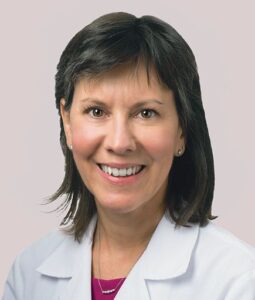 Headshot of Elizabeth McNally, MD, PhD, a white woman with shoulder-length dark hair in a white lab coat.