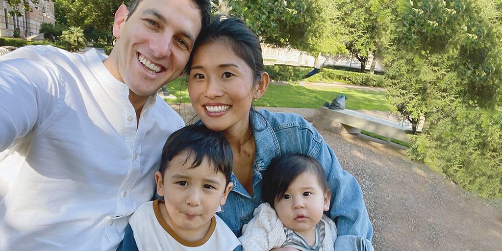 Daniel Barvin takes a selfie in a garden with his wife and two young children.