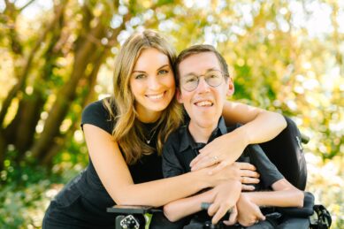 Hannah and Shane Burcaw smile outside in black shirts