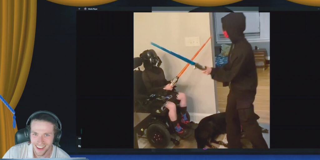 Screenshot of two children in black clothes having a lightsaber fight during the MDA Let’s Play Talent Show.