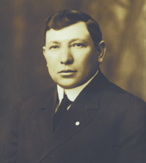 Sepia tone photograph of Lewis Golub in a suit jacket and tie