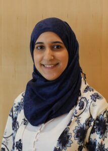 Headshot of Heba Al-Rayess, MD, a woman with a medium light skin tone wearing a dark blue hijab.