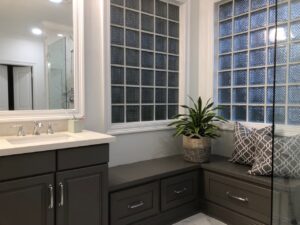 Bathroom sink next to built-in bench seating.