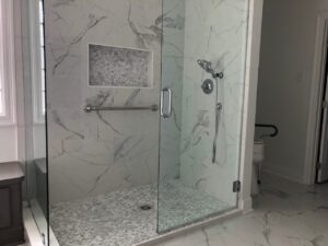 Accessible shower with low threshold and doorless entry.