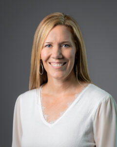 Headshot of Hilary Lott, a woman with light skin and long light brown hair.