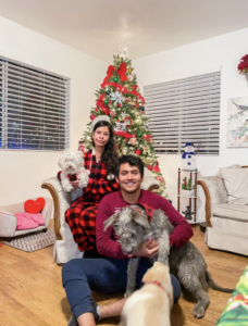 Nora Ramirez and her husband with their adopted dogs during Christmas