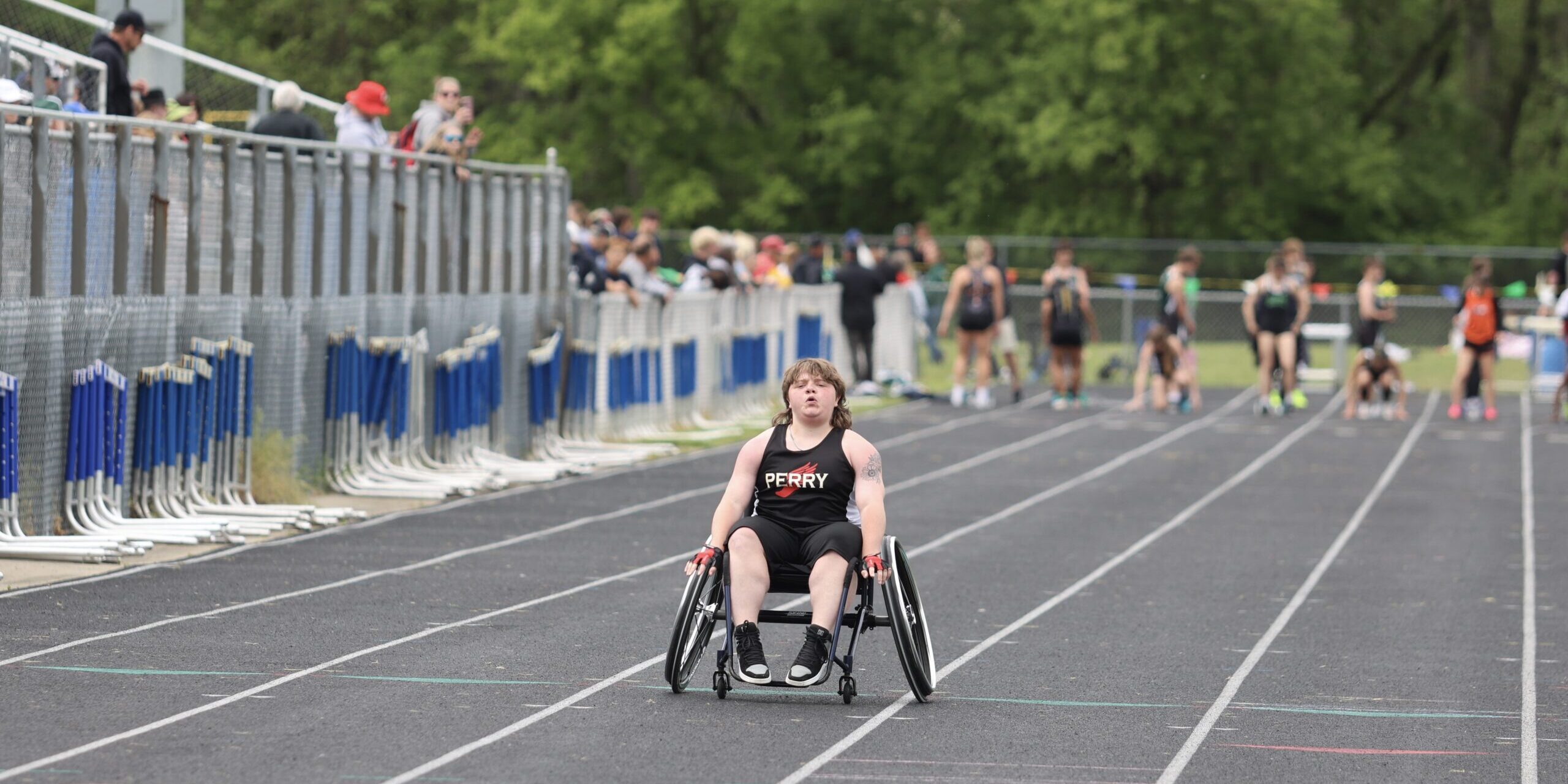 Alec Chapman races on a track in his adapted bike.