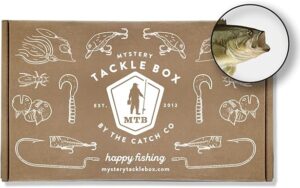 A brown box with fishing lures that says Mystery Tackle Box