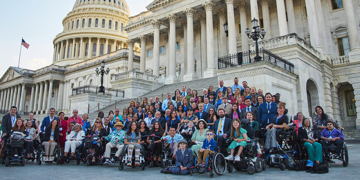 A large group of advocates gather in front of the Capitol building