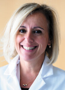 Headshot of Rita Perlingeiro, a woman with straight, shoulder-length blond hair and light skin.