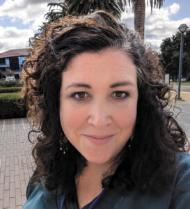 Selfie of Marissa Lozano in an outdoor courtyard on a sunny day.