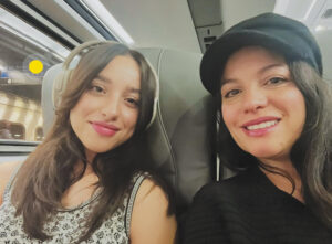 Selfie of Bevi Zelaya and her teen daughter Leah seated together on an Amtrak train.