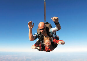 Action shot Kristy Durso tandem skydiving.