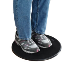 Closeup of a person’s feet standing on a flat, rotating disc.