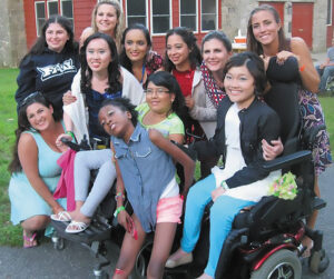 Caroline LeMay pictured with friends dressed up for an MDA Summer Camp dance in 2013