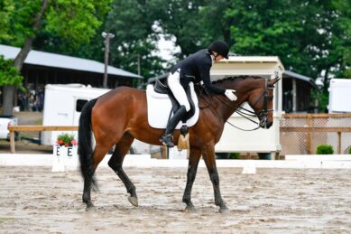 A woman rides a horse