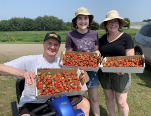 Jon and his family picking strawberries. 