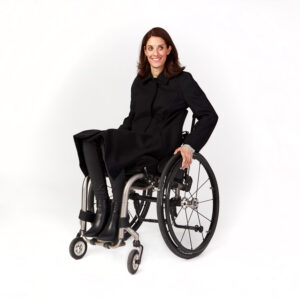 Product photo of a woman in a wheelchair wearing a black knee-length coat.