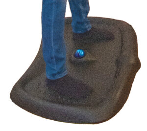 Black rubber mat with a person standing on it.