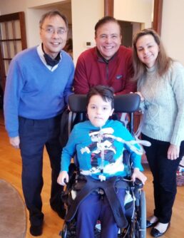 Michio Hirano, MD, a neurologist and researcher at Columbia University poses with Arturito Estopinan, who received an experimental therapy through expanded access, and his parents.