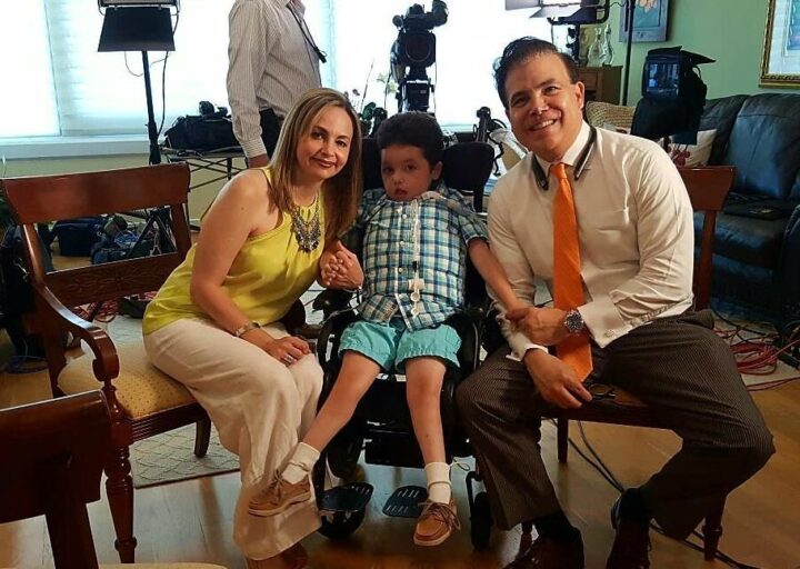 Arturito Estopinan, a teen who received a new therapy for the rare TK2d disease, seated in a wheelchair between his parents, Olga and Art.