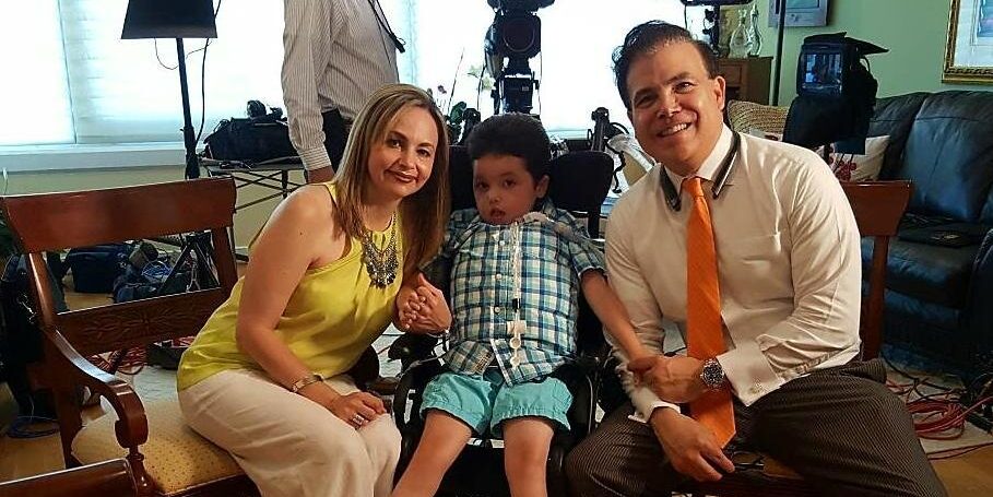 Arturito Estopinan, a teen who received a new therapy for the rare TK2d disease, seated in a wheelchair between his parents, Olga and Art.