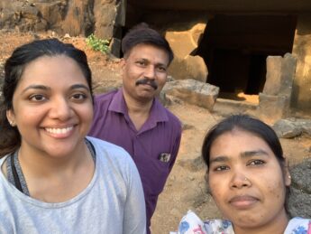 Two woman and a man pose in India